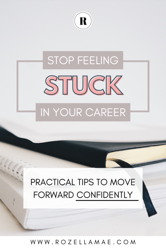 A minimalist Pinterest graphic with the text Stop Feeling Stuck in Your Career and Practical Tips to Move Forward Confidently, placed over a clean background featuring a notebook and black ribbon bookmark. The design is professional and modern, with soft pink and gray tones.